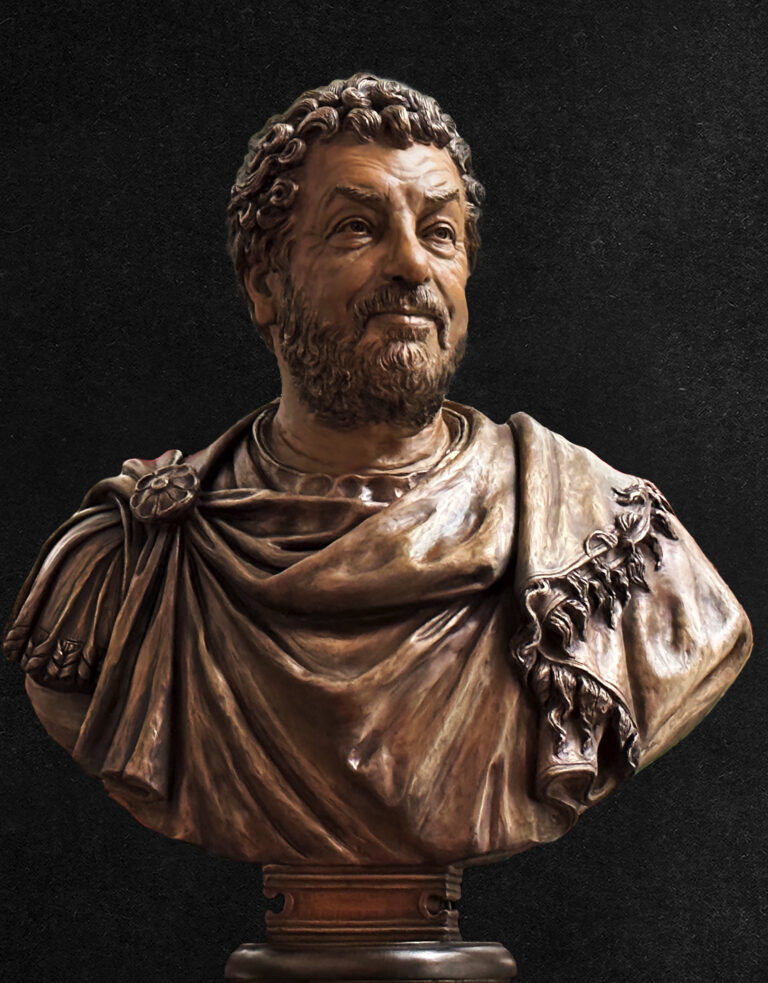 Front view of a bronze bust depicting a classical, bearded male figure in draped garments, created as a commissioned sculpture for use on a television set.