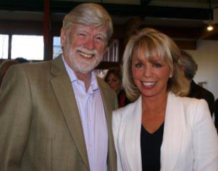 David Roosevelt and Carolyn Palmer standing together indoors during an unveiling event, smiling toward the camera.