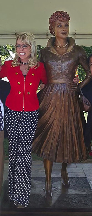 Sculptor Carolyn D. Palmer standing beside the finished bronze Lucille Ball statue at the unveiling event.