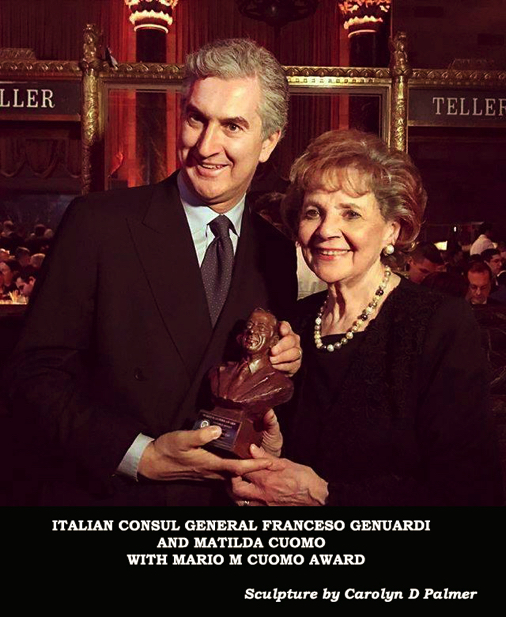 Italian Consul and Matilda Cuomo standing together at a formal event, holding a bronze bust award presented for public service recognition.