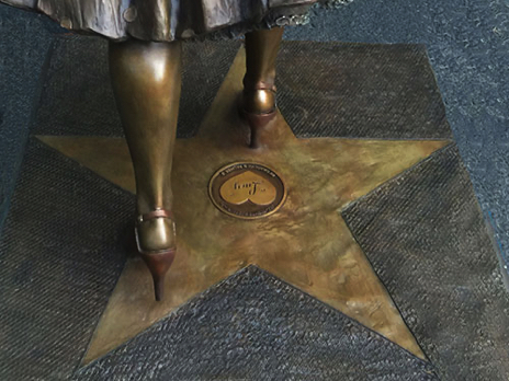 Close-up view of the bronze star set into the base beneath the Lucille Ball statue.