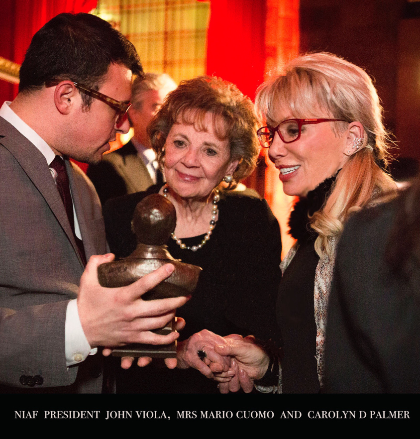 Matilda, John, and Carolyn examining and discussing a Mario Cuomo bronze bust at a National Italian American Foundation event.