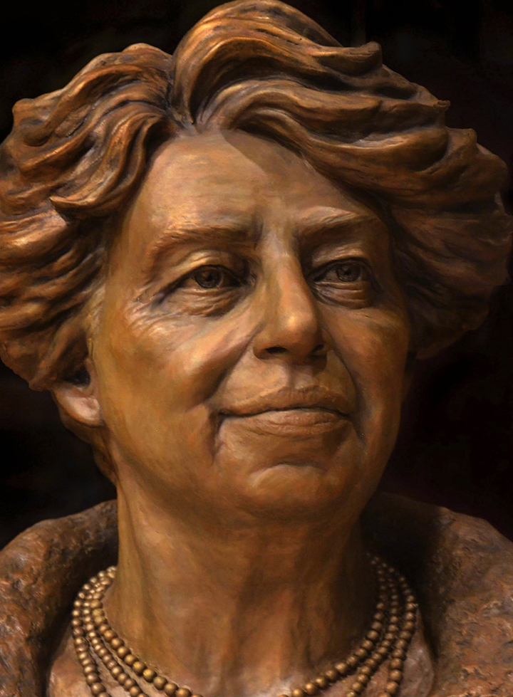Bronze portrait bust of Eleanor Roosevelt shown from the front, wearing a necklace and textured jacket.