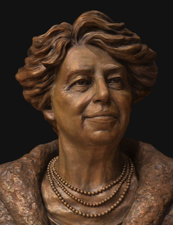 Bronze portrait bust of Eleanor Roosevelt shown from the front, wearing a necklace and textured jacket.