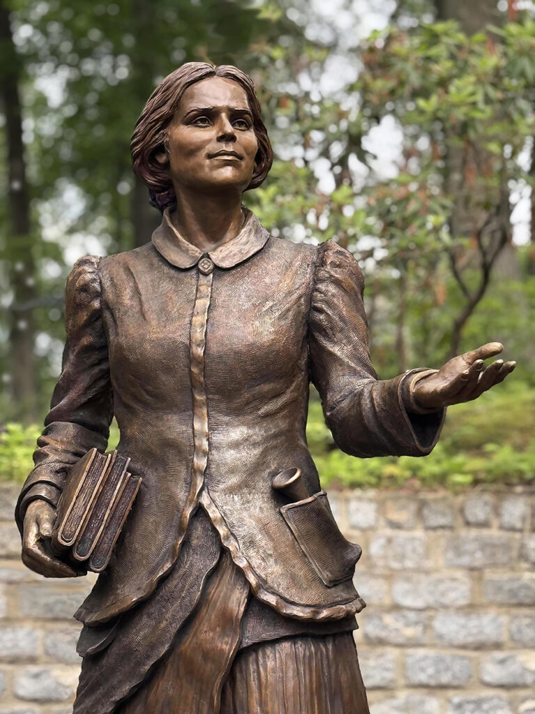 Close-up view of the bronze statue of Dr. Elizabeth Blackwell, showing detailed facial expression and period clothing.